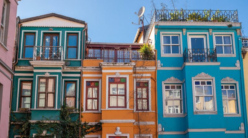 a row of multicolored buildings with balconies